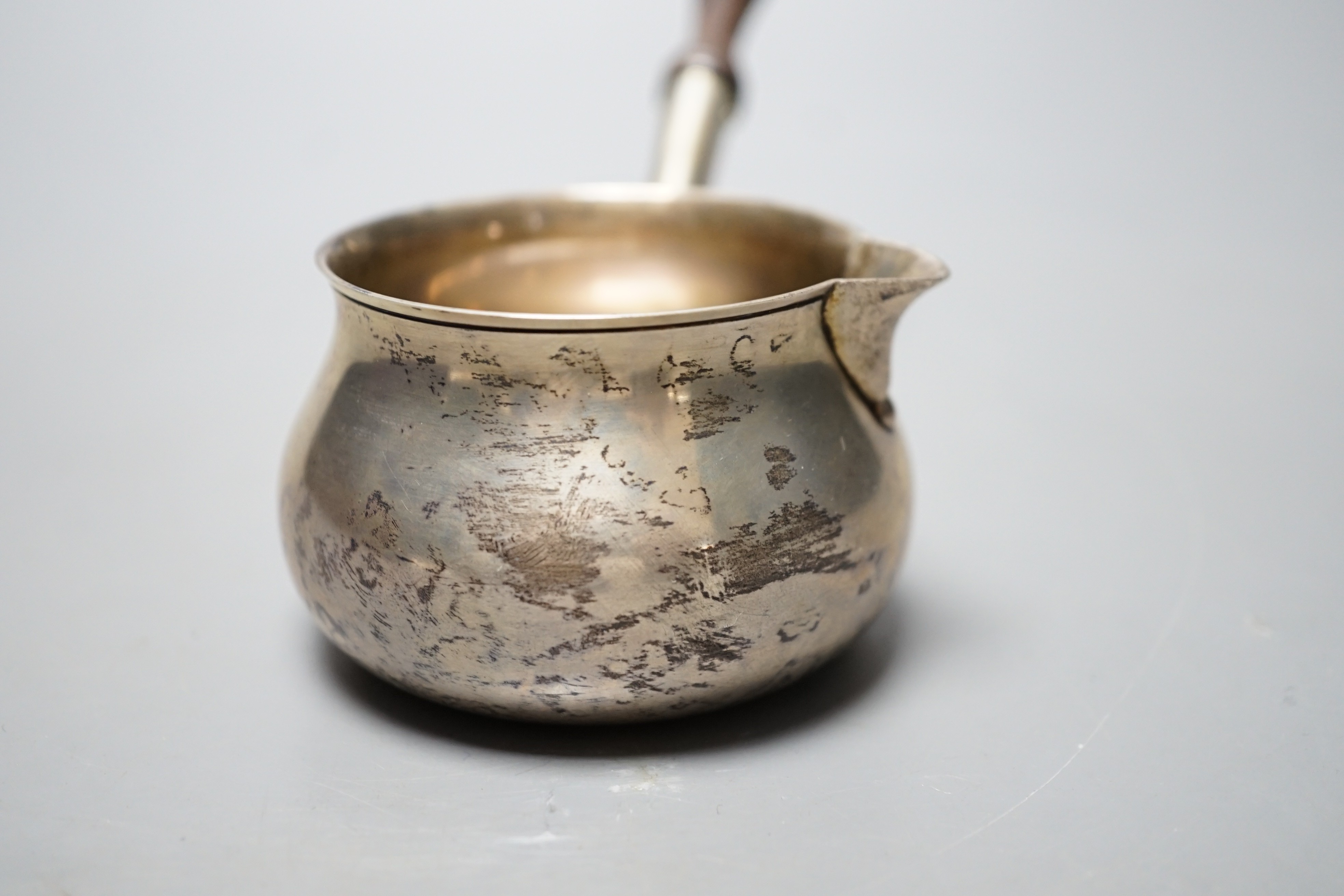 A modern silver brandy warmer, with turned wooden handle, Bryan Savage, London, 1973, 16.8cm, gross 81 grams, in an Asprey box.